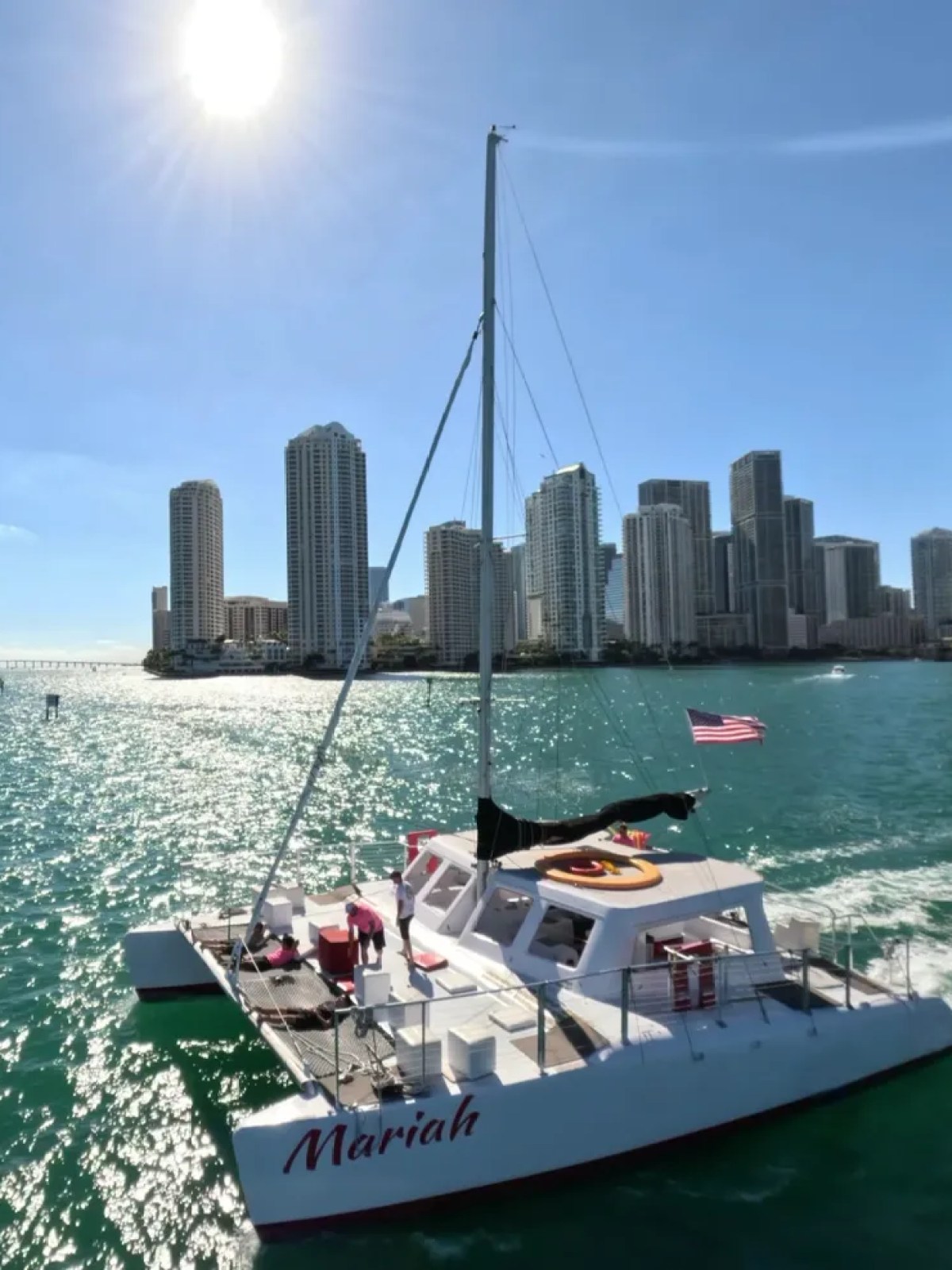 a small boat in a body of water with a city in the background
