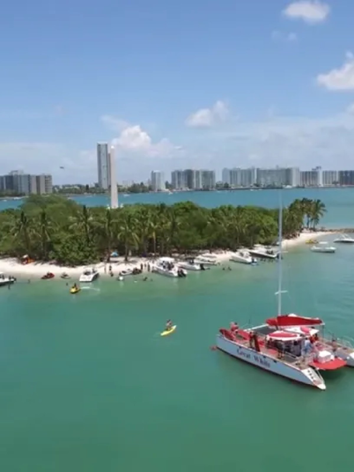 a small boat in a body of water with a city in the background