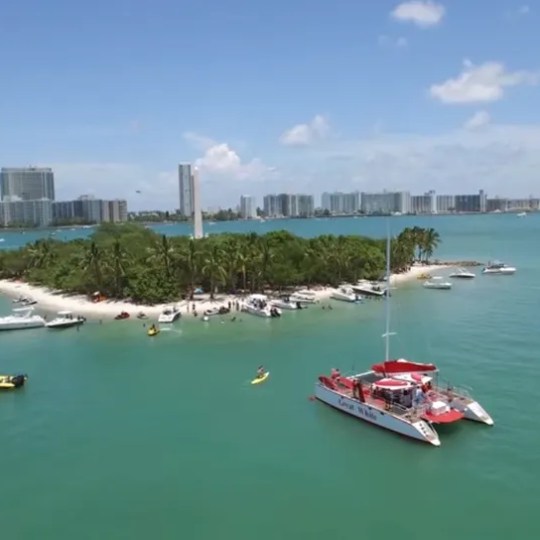 a small boat in a body of water with a city in the background