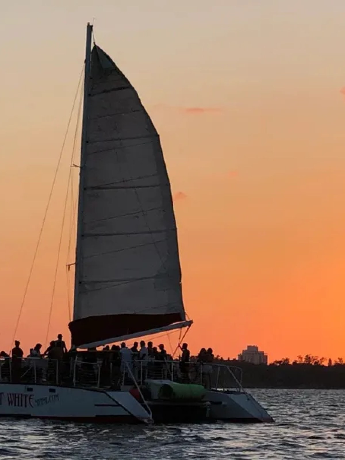 a sunset behind a boat on a body of water