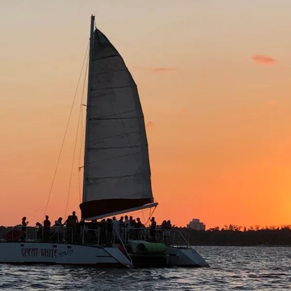 a sunset behind a boat on a body of water